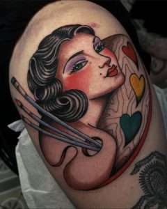 An American traditional lady head alongside a paint palette with brushes by Jacksonville artist Julissa Yaselin, done in bright colors with bold lines
